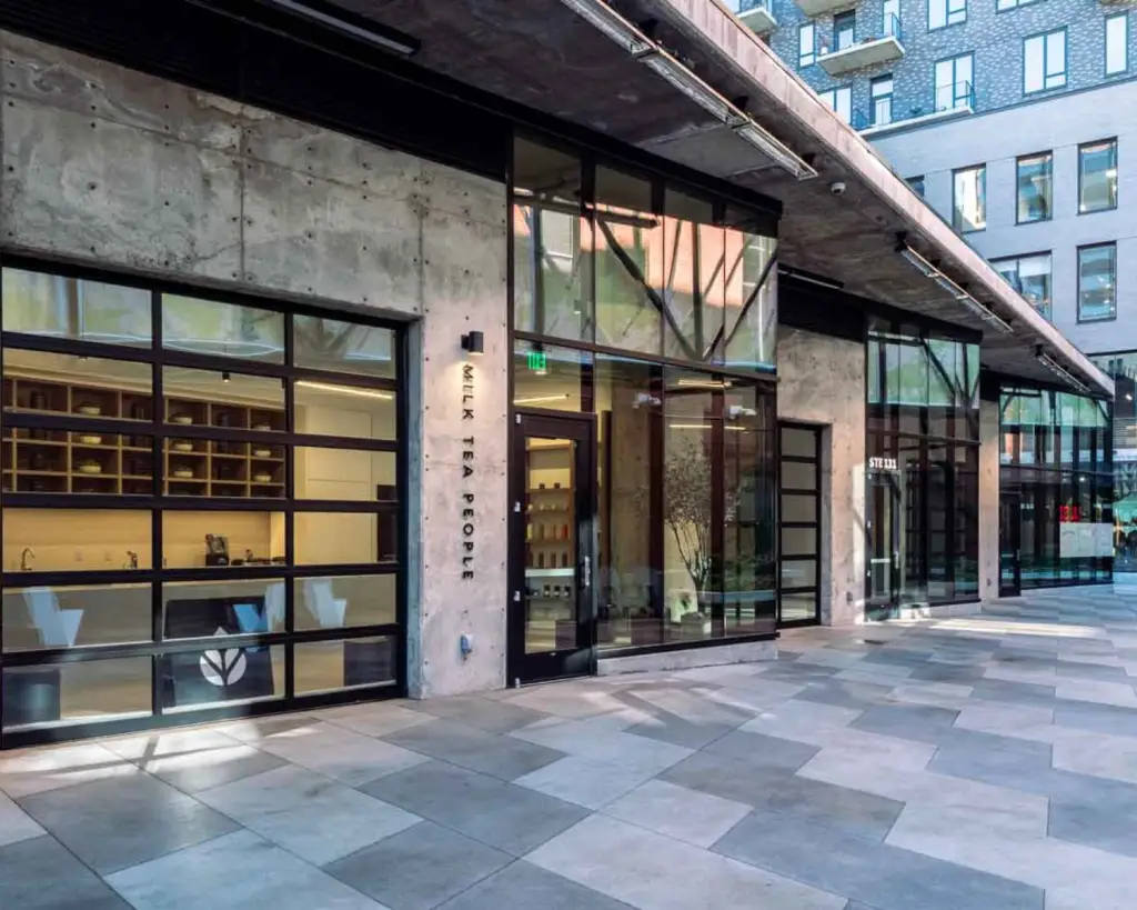 Image of a modern tea and coffee shop exterior with glass garage door.