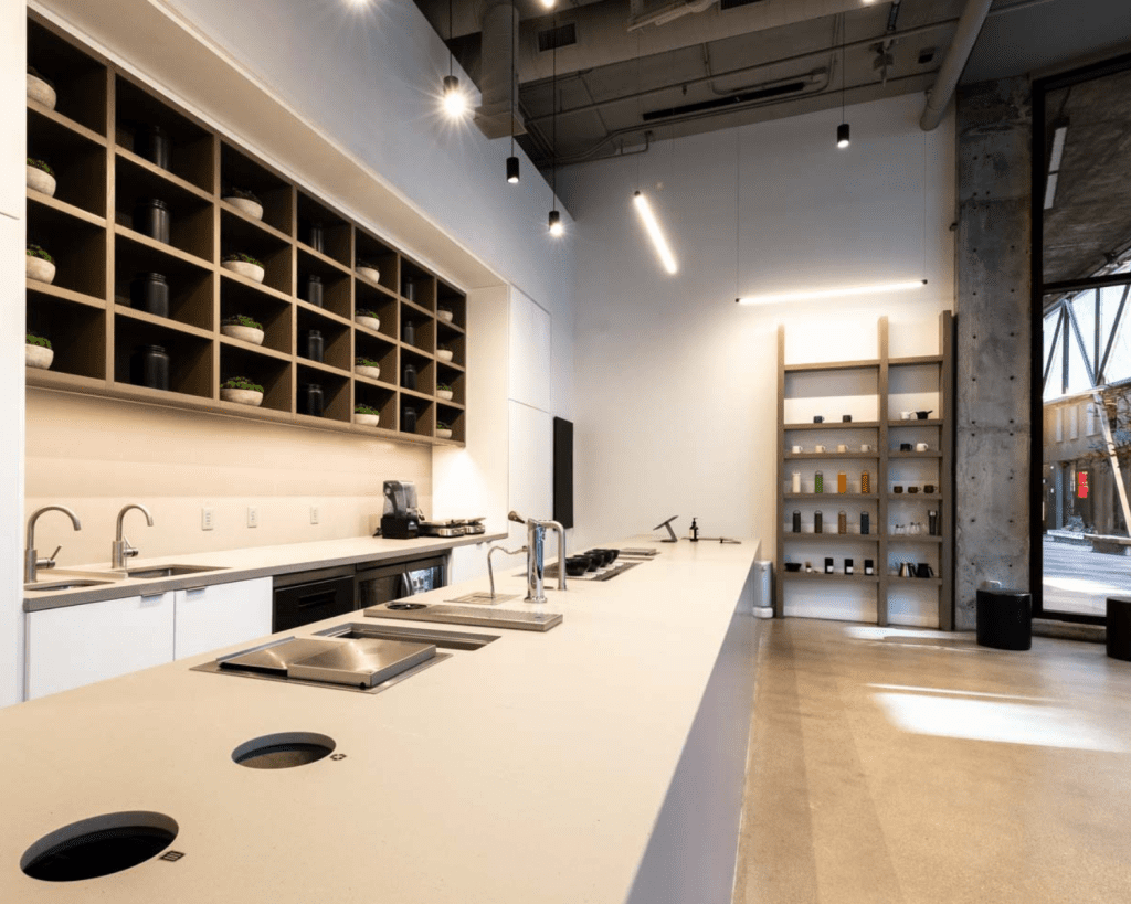 Image of a modern tea and coffee shop interior with bar and shelving.