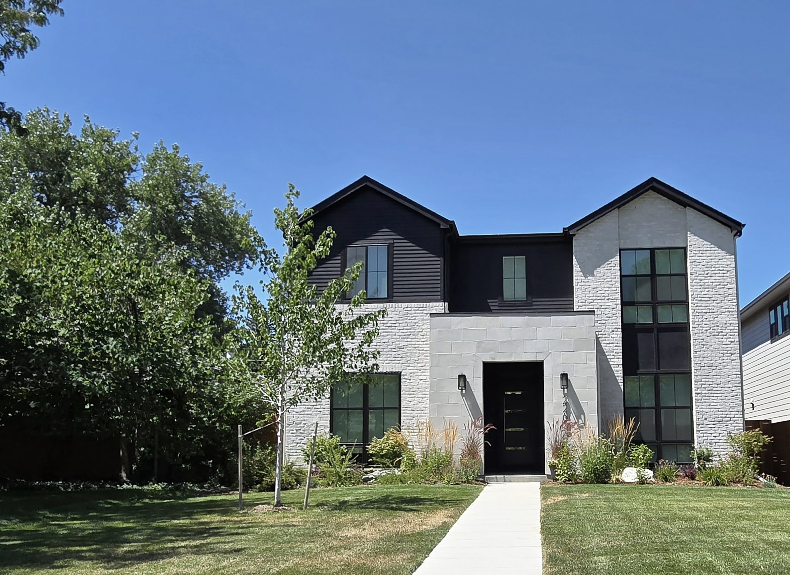 2265-s-monroe Image of a contemporary luxury home with tree in yard and blue sky.