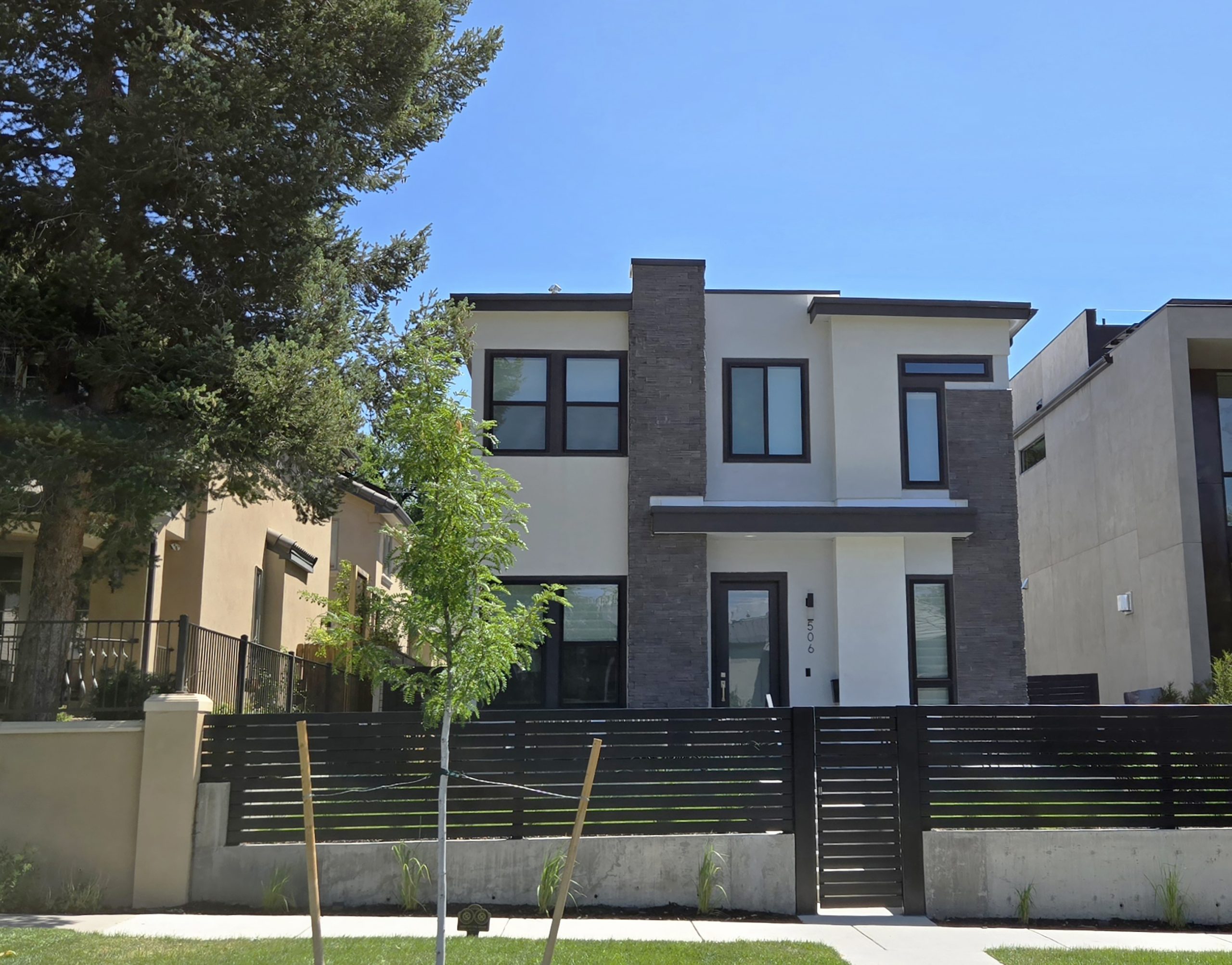 506-milwaukee Image of a contemporary luxury home with boxy shape and fenced in yard.
