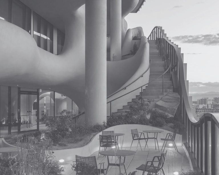 Black and white photograph of an exterior stairway and sitting area at One River North in Denver, Colorado.
