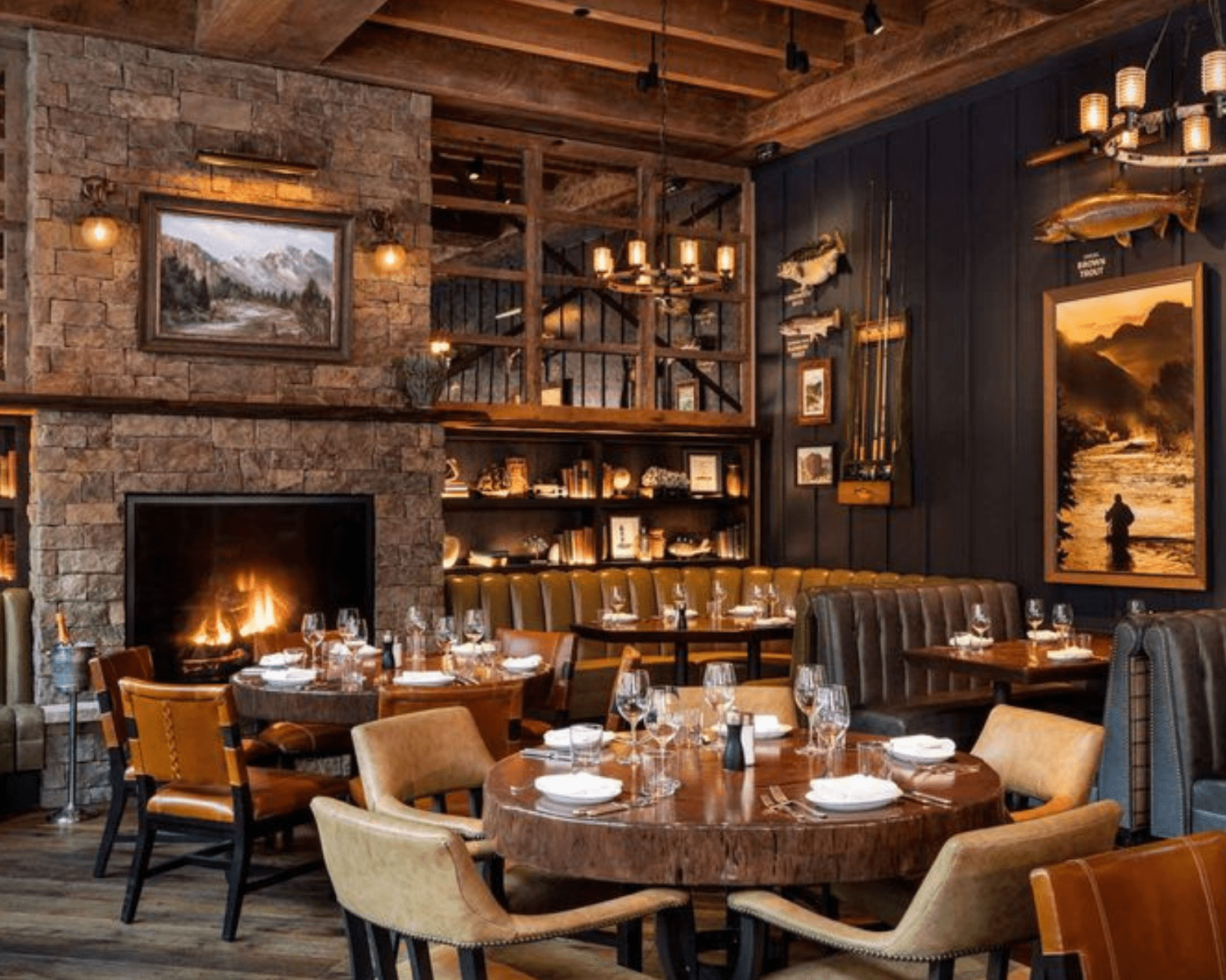 WATER-GRILL-DENVER-1 Image of a woodsy restaurant interior with brick fireplace, painting, found decor, and leather seating.