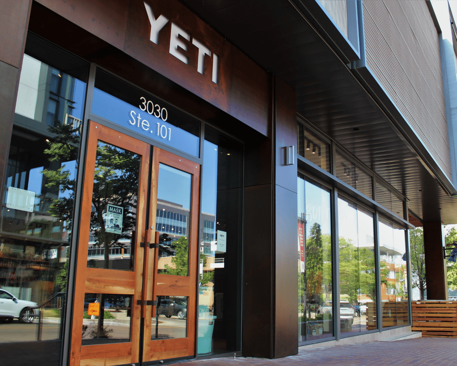 YETI-DENVER Image of a Yeti retail store entrance with large sign and wooden doors.