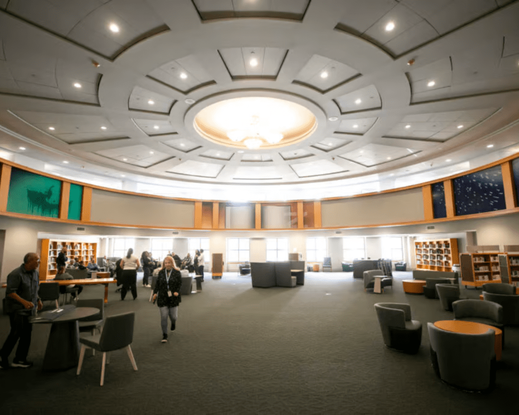 Interior image of the Denver Central Library with wide open space, round white ceiling, and natural light.